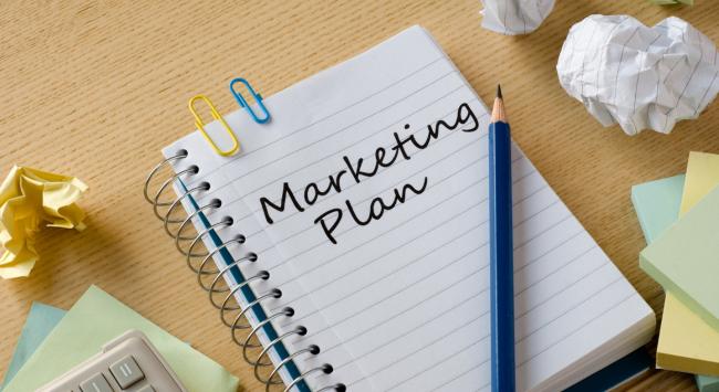 notebook that says marketing plan