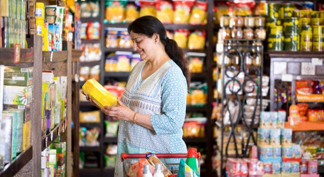 woman smiling holding food product