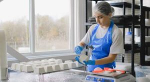 woman using food molds in kitchen